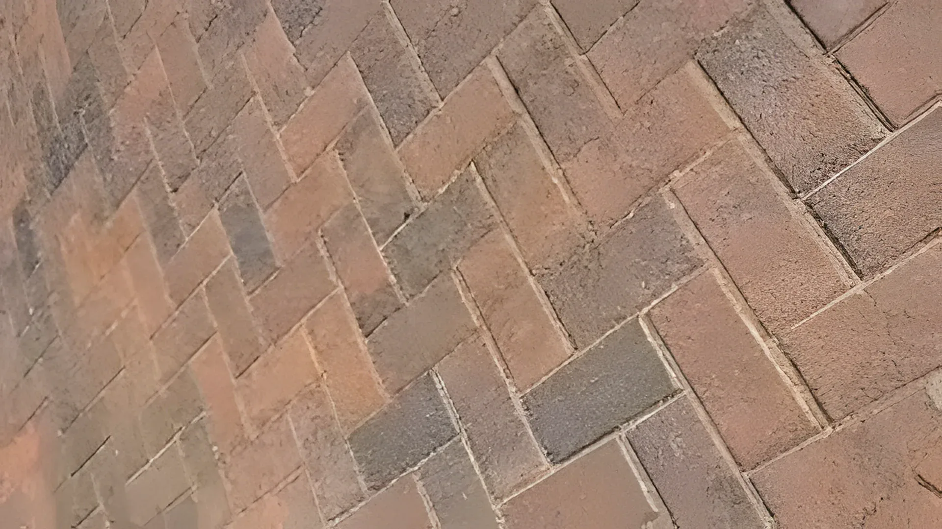 Freshly sealed herringbone pavers with rich, even color and clean joints after paver sealing